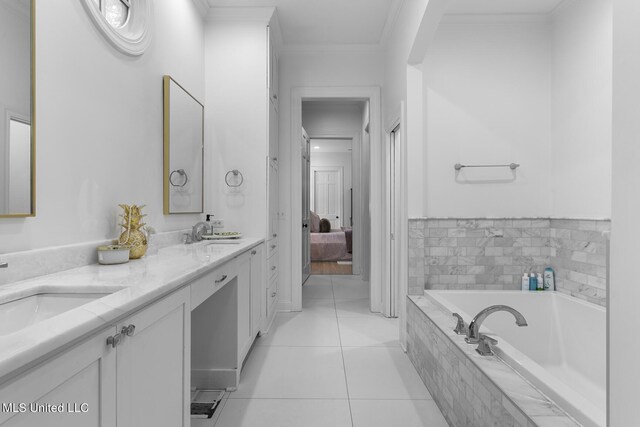 3844 Hawthorn Dr, Jackson, MS 39216 - ensuite bathroom featuring double vanity, a sink, a bath, tile patterned floors, and ornamental molding