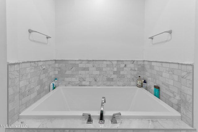 bathroom with a relaxing tiled tub