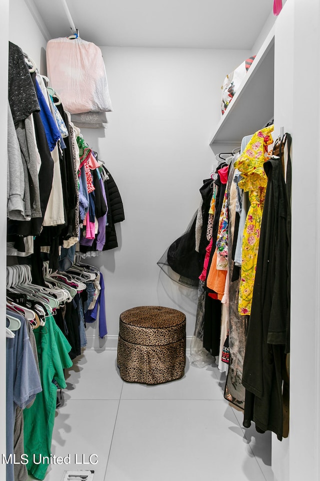 spacious closet featuring light tile patterned flooring