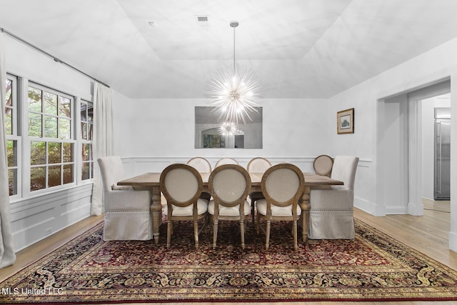 3844 Hawthorn Dr, Jackson, MS 39216 - dining space with light wood finished floors, visible vents, and a notable chandelier