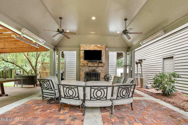 view of patio with ceiling fan and an outdoor stone fireplace