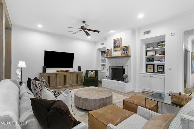 3844 Hawthorn Dr, Jackson, MS 39216 - living room with a ceiling fan, recessed lighting, visible vents, built in shelves, and a brick fireplace