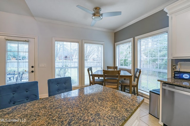 dining room with ceiling fan, ornamental molding, and light tile patterned flooring