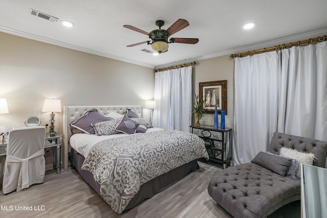 bedroom with ceiling fan, hardwood / wood-style flooring, and ornamental molding