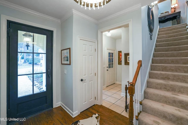 entryway with hardwood / wood-style floors, plenty of natural light, and crown molding