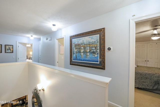 hallway with a textured ceiling