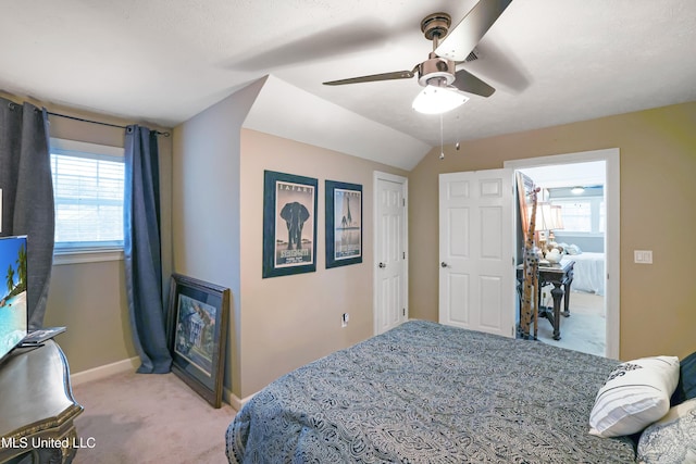 bedroom with light carpet, ceiling fan, and lofted ceiling