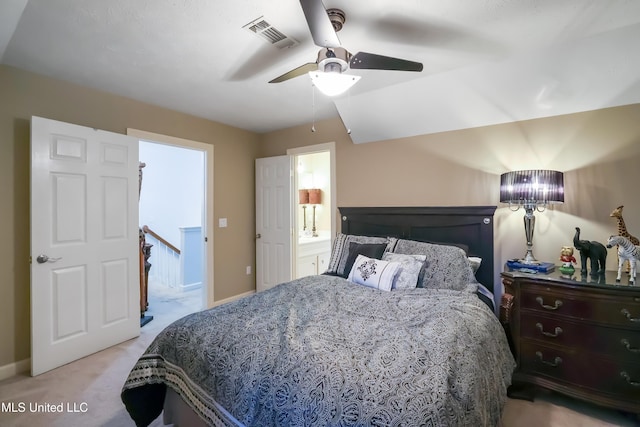 bedroom with ensuite bath, light carpet, and ceiling fan