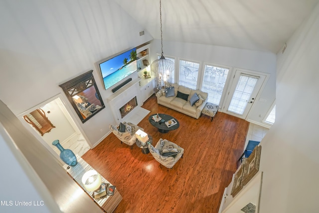 living room with a chandelier and vaulted ceiling