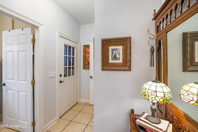 doorway with light tile patterned floors