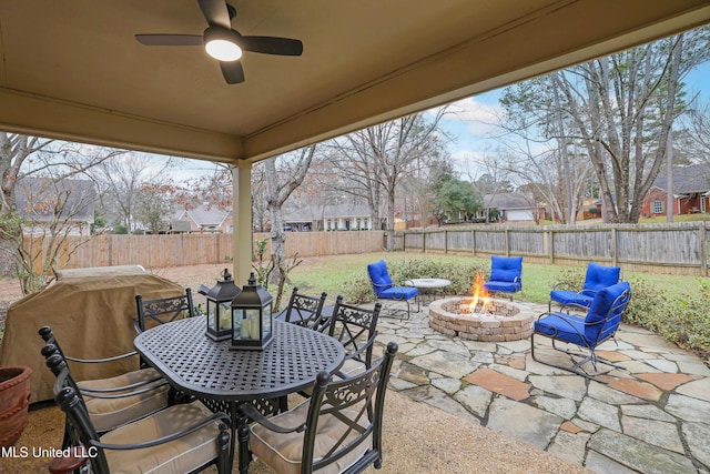 view of patio featuring area for grilling, an outdoor fire pit, and ceiling fan