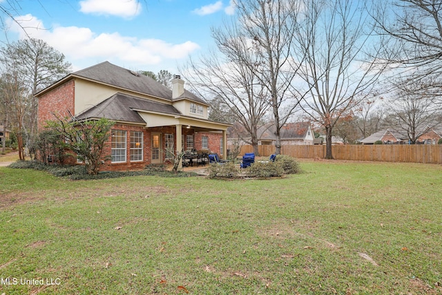 exterior space with a lawn and a patio