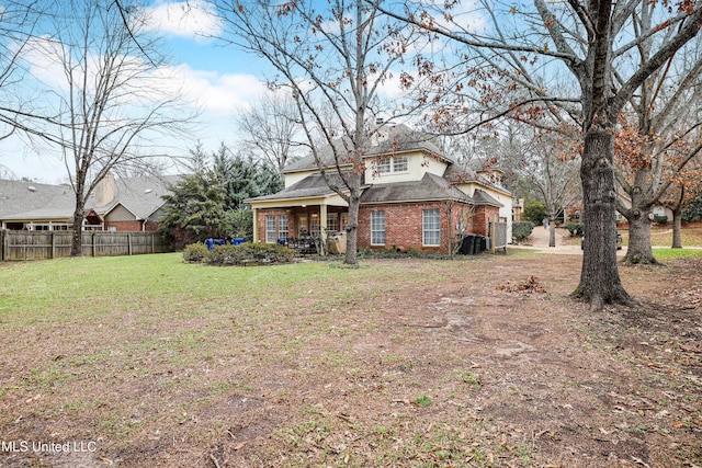 rear view of house with a yard