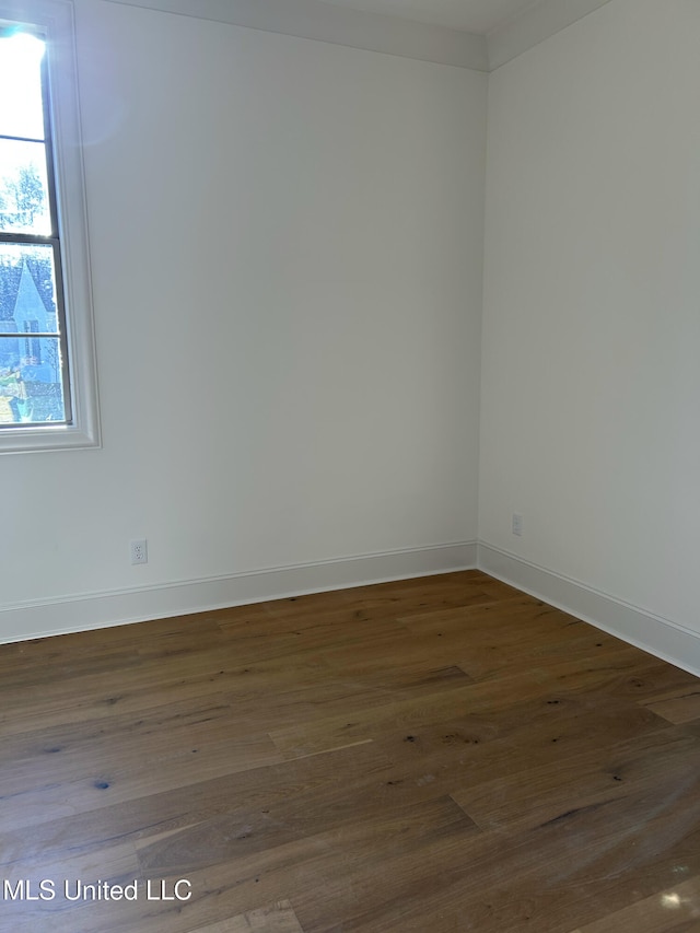 unfurnished room featuring dark hardwood / wood-style floors