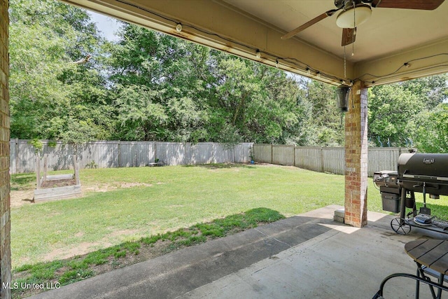 view of yard with a fenced backyard, a patio, and ceiling fan