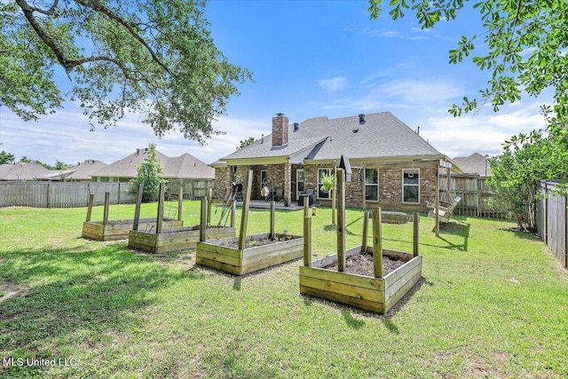 view of yard with a fenced backyard and a garden