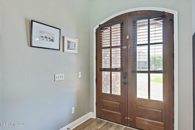 entryway with baseboards, french doors, and wood finished floors