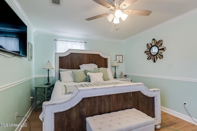 11162 New York St, Bay Saint Louis, MS 39520 - bedroom with crown molding, wood finished floors, baseboards, and ceiling fan