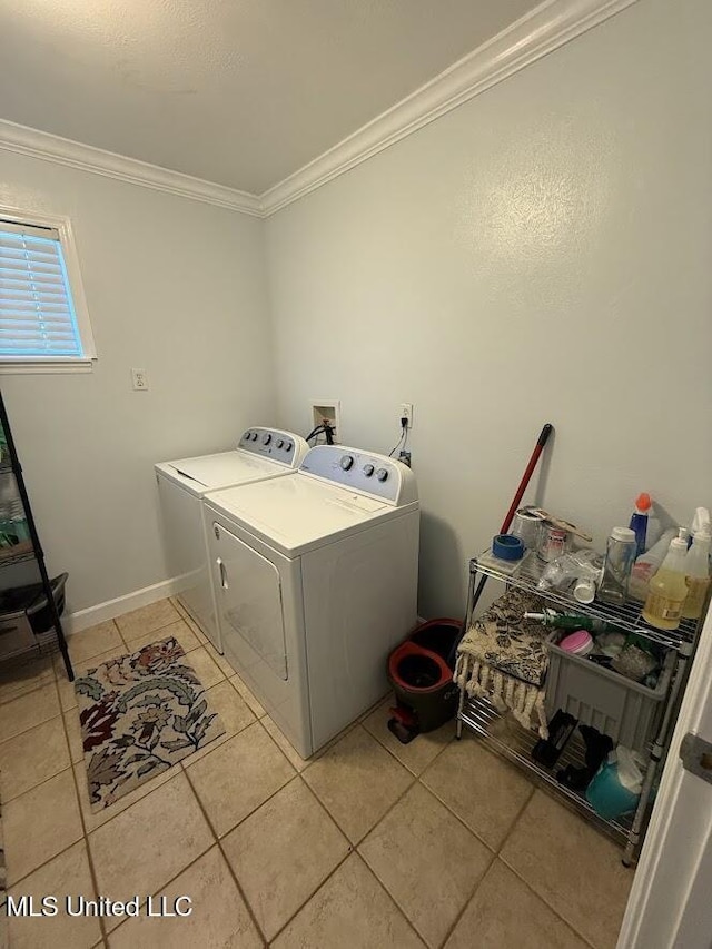 11162 New York St, Bay Saint Louis, MS 39520 - washroom with separate washer and dryer, crown molding, and light tile patterned floors