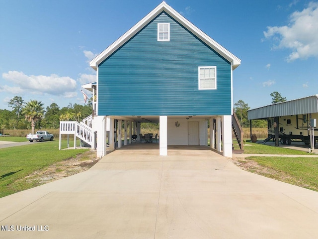 11162 New York St, Bay Saint Louis, MS 39520 - view of home's exterior featuring stairs, a carport, a lawn, and driveway