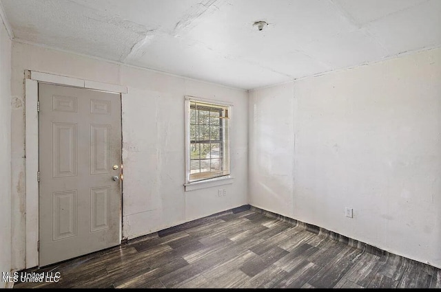 unfurnished room with dark wood-style flooring