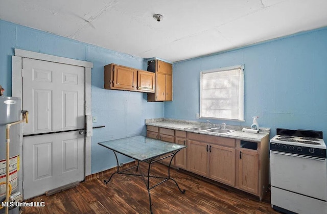 kitchen featuring gas water heater, dark wood finished floors, light countertops, white electric range, and a sink