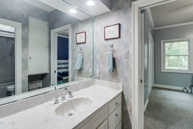 bathroom featuring ornamental molding, vanity, and toilet