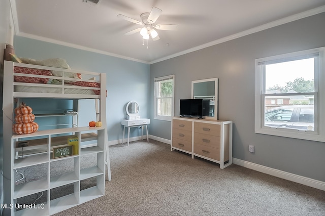 bedroom with ceiling fan, ornamental molding, and carpet floors