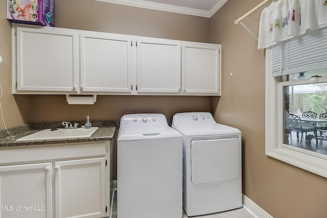 washroom with cabinets, crown molding, sink, and independent washer and dryer