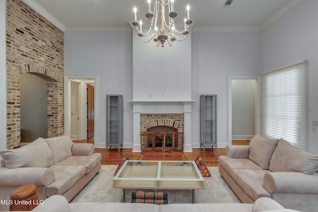 living room with light hardwood / wood-style floors, crown molding, and a high ceiling