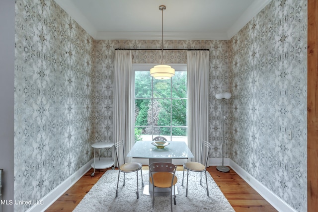 dining space featuring crown molding and hardwood / wood-style floors