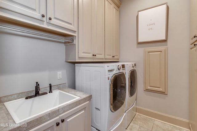 laundry room featuring cabinets, sink, washing machine and clothes dryer, and light tile patterned floors