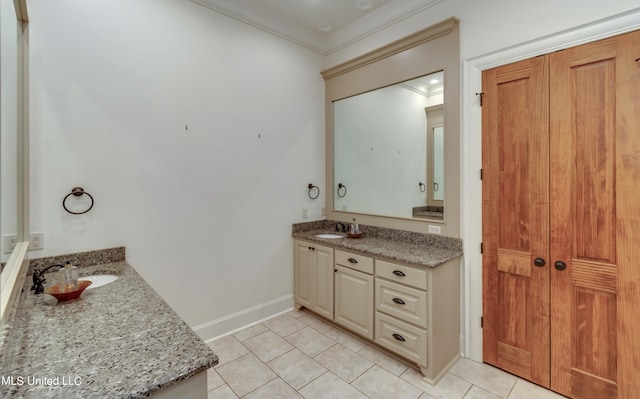 bathroom with vanity, ornamental molding, and tile patterned flooring