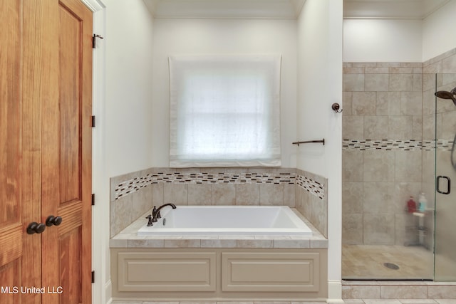 bathroom with tile patterned floors and shower with separate bathtub