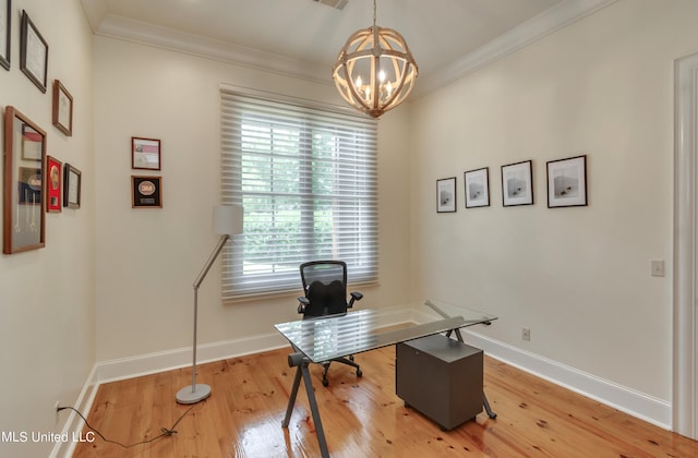 home office with ornamental molding, an inviting chandelier, and hardwood / wood-style floors