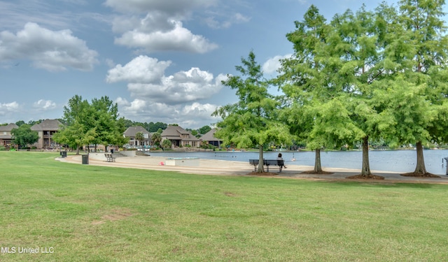 surrounding community featuring a yard and a water view