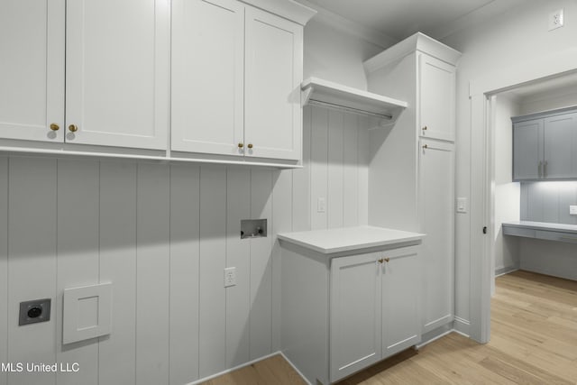 laundry room featuring cabinets, washer hookup, hookup for an electric dryer, and light hardwood / wood-style floors