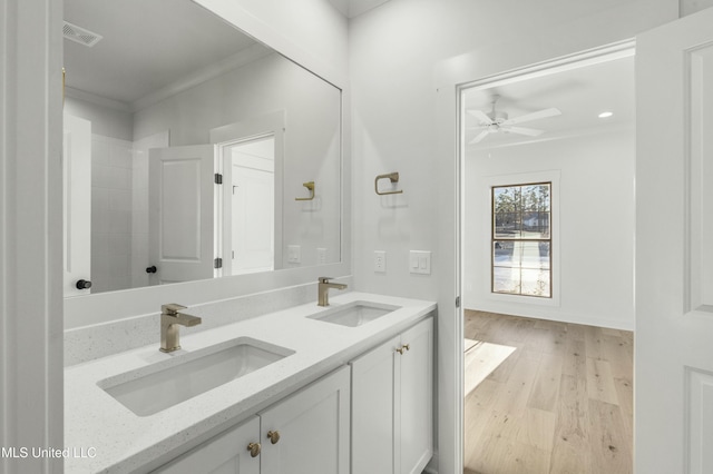 bathroom featuring hardwood / wood-style flooring, ceiling fan, vanity, and crown molding