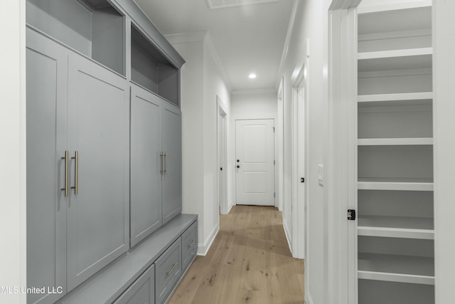 mudroom featuring crown molding and light hardwood / wood-style flooring