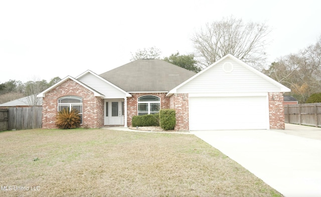 single story home featuring a garage, driveway, fence, a front lawn, and brick siding