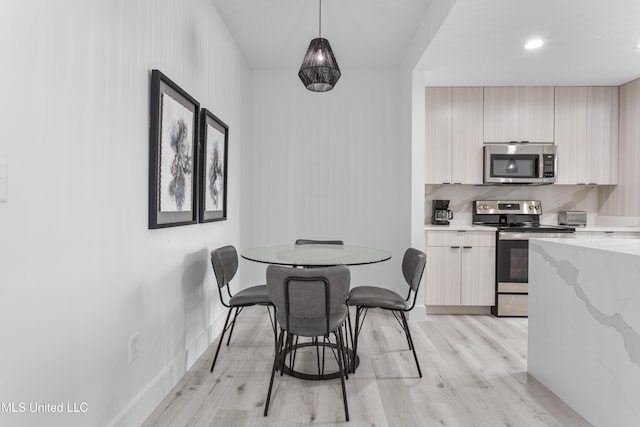 dining space with light hardwood / wood-style flooring