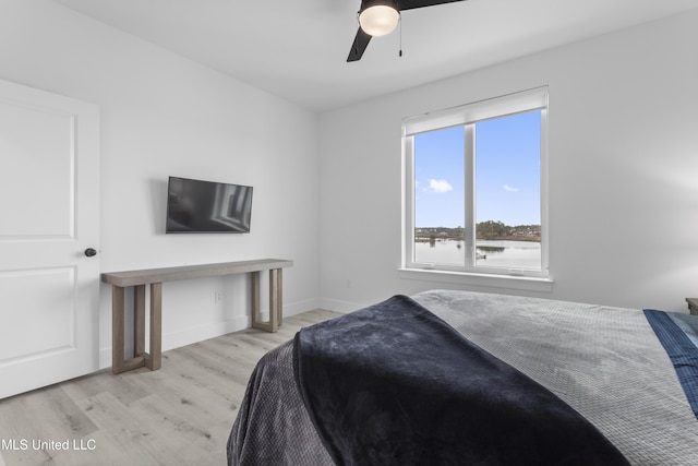 bedroom with ceiling fan and light wood-type flooring