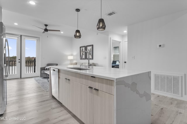 kitchen with a large island, sink, pendant lighting, light stone countertops, and stainless steel dishwasher