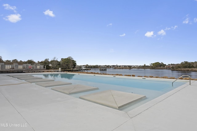 view of swimming pool with a water view