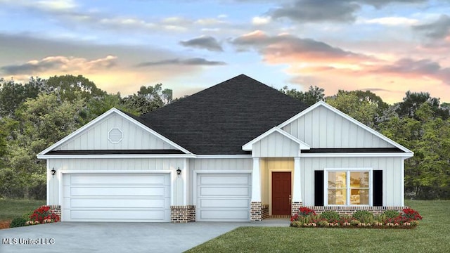 view of front of house with a garage and a yard