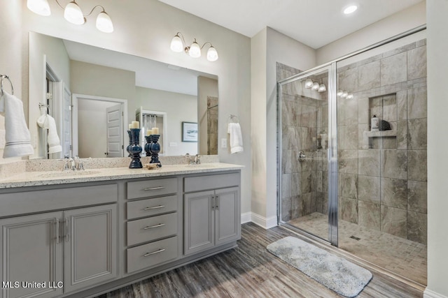 bathroom featuring vanity, wood-type flooring, and an enclosed shower