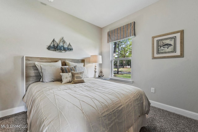 bedroom featuring dark carpet