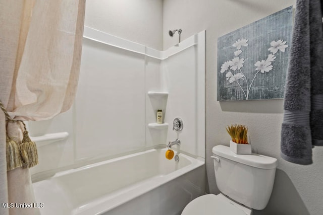 bathroom featuring washtub / shower combination and toilet