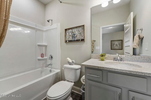 full bathroom featuring vanity, bathtub / shower combination, and toilet