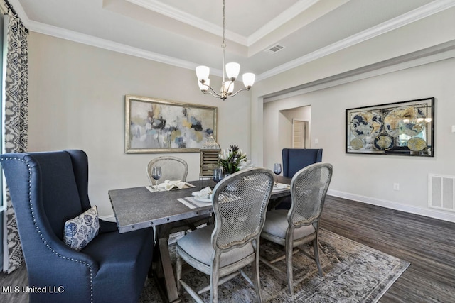 dining space featuring crown molding, dark hardwood / wood-style flooring, and a tray ceiling